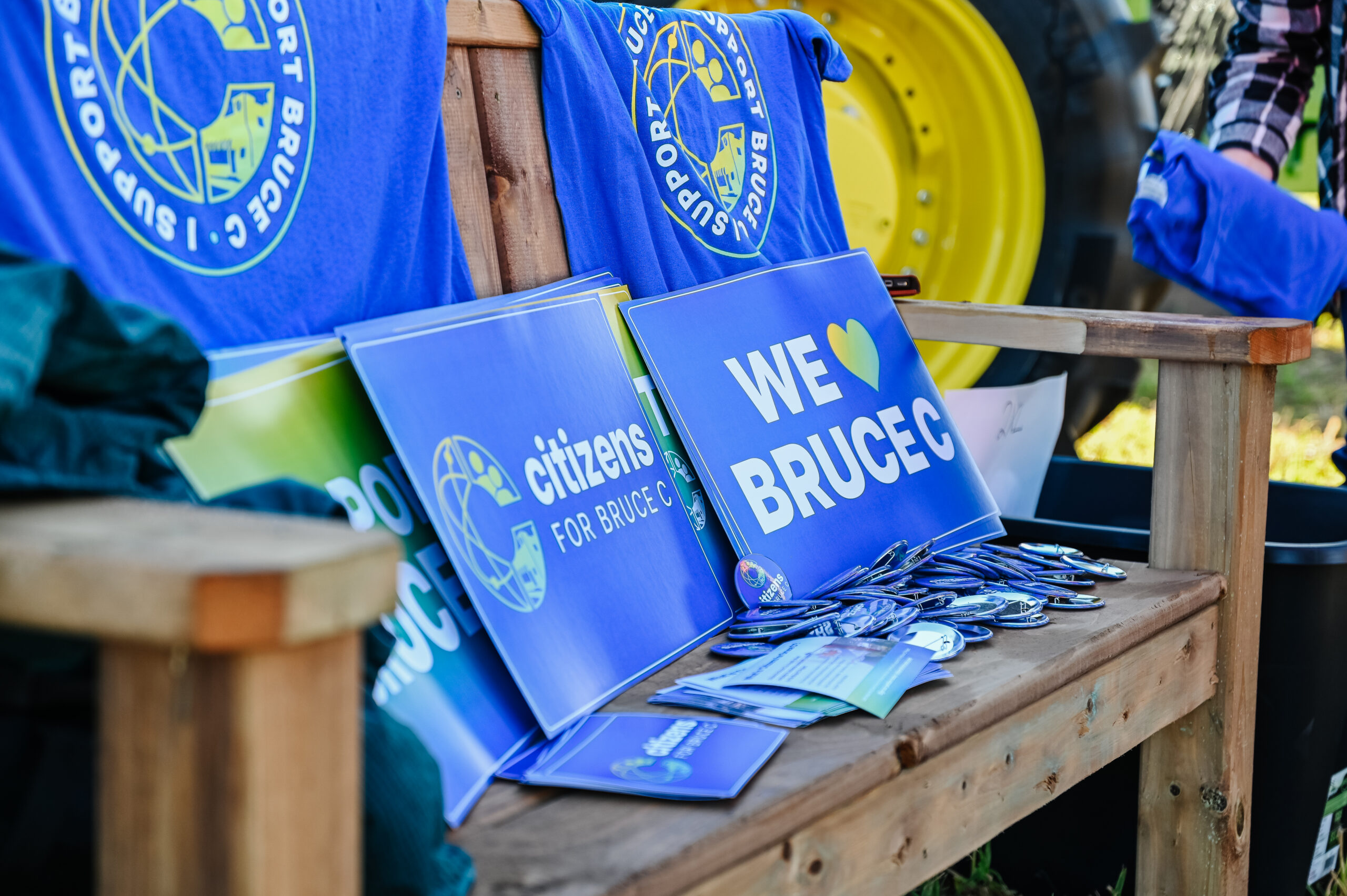 A photo of a bench with some Citizens for Bruce C merch displayed on it.